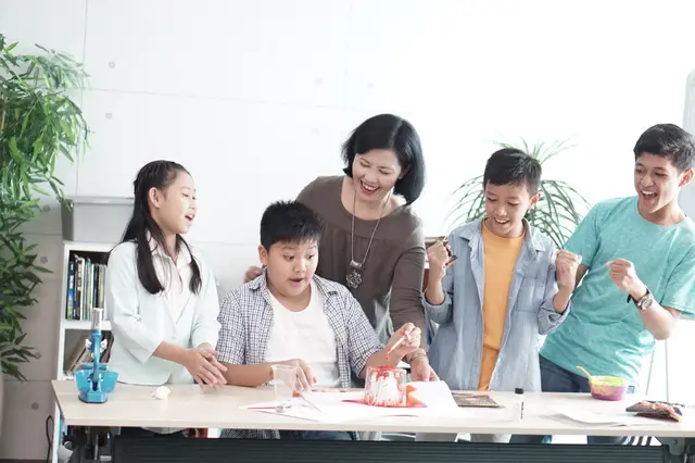 Anak-anak dan pengajar melakukan eksperimen bersama